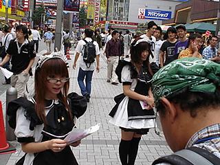 Several cosplayers handing out flyers at a subway station